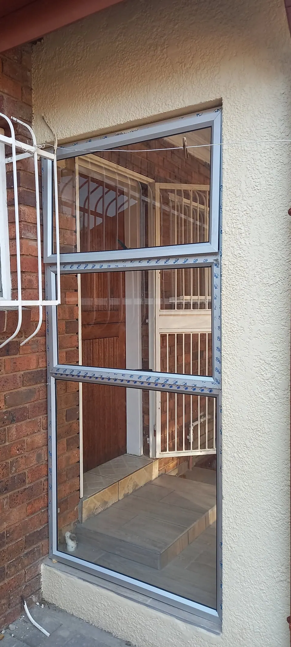 Steel-framed security window on a face-brick wall