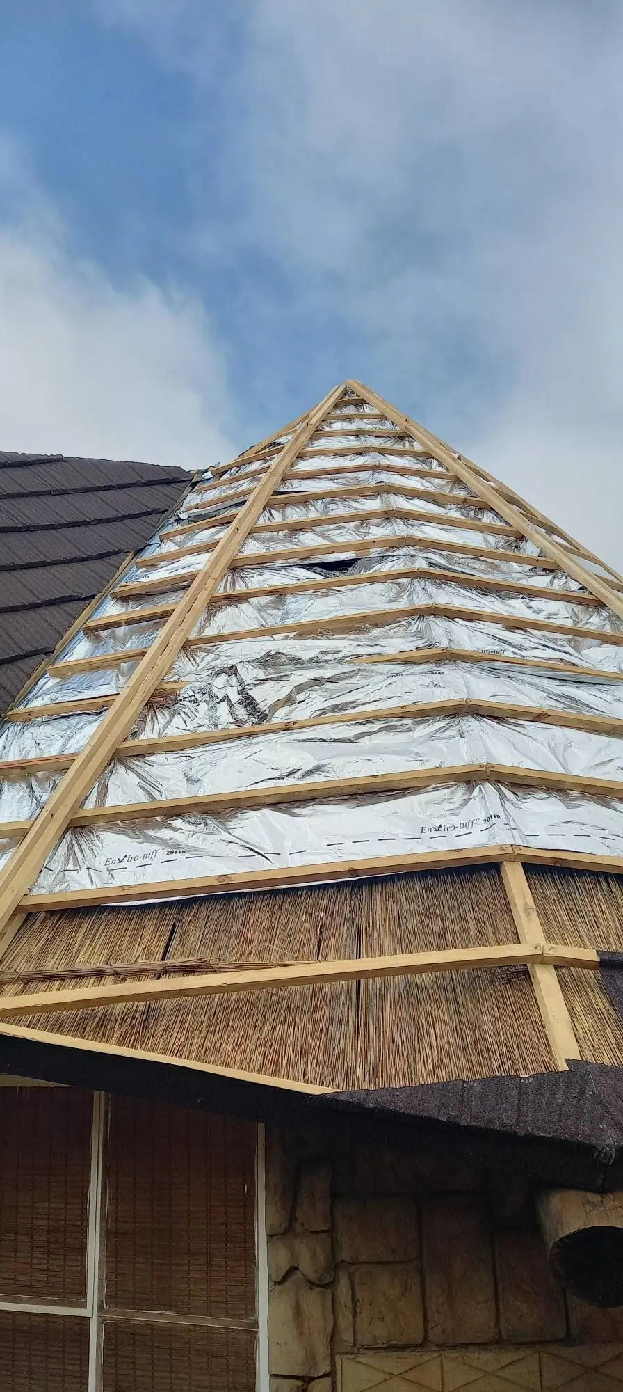 Thatch roof with reflective foil insulation